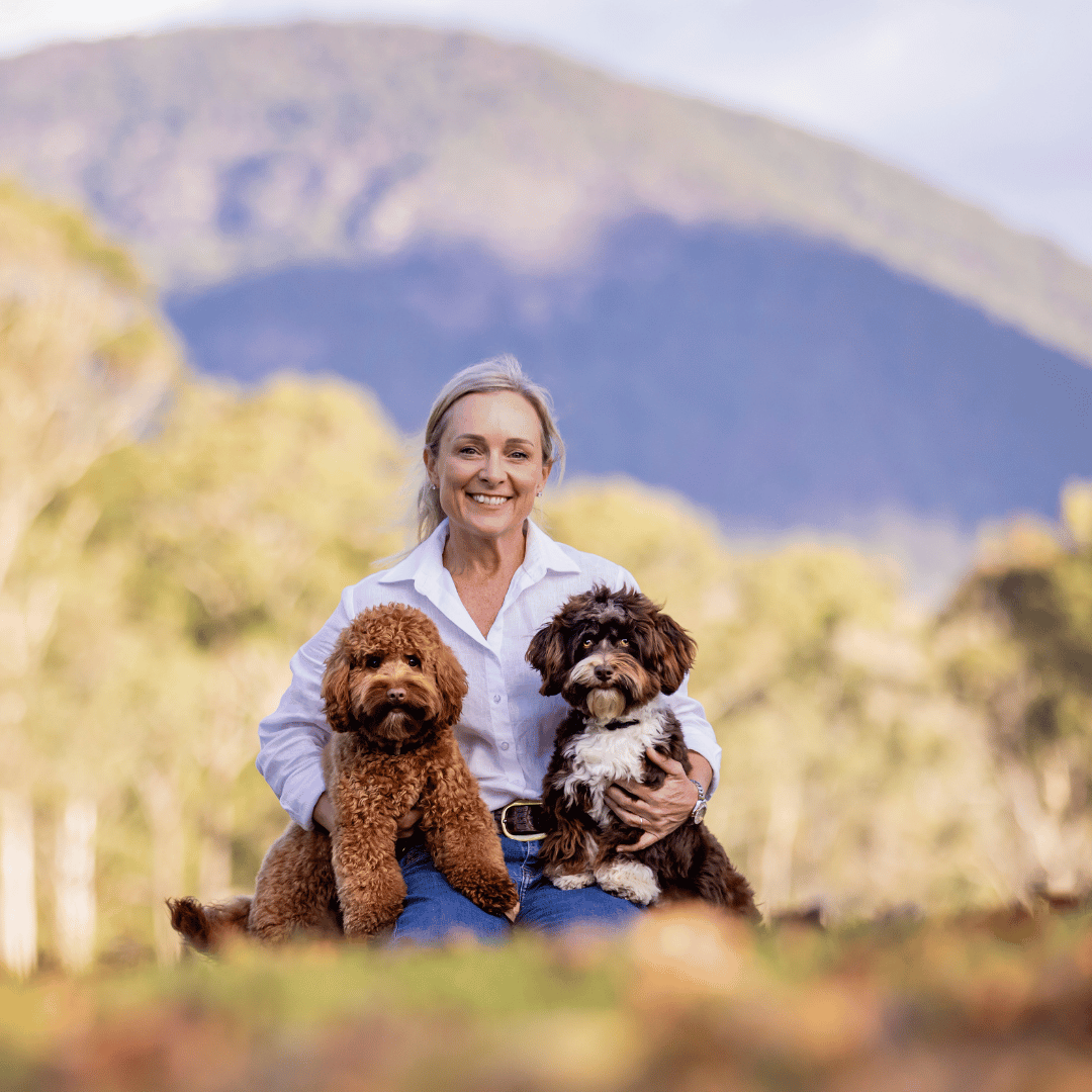 Sarah owner of waterhill with her dogs on sunshine coast property